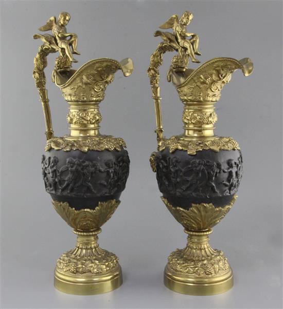 A pair of Renaissance style bronze and ormolu ewers, 20.5in.